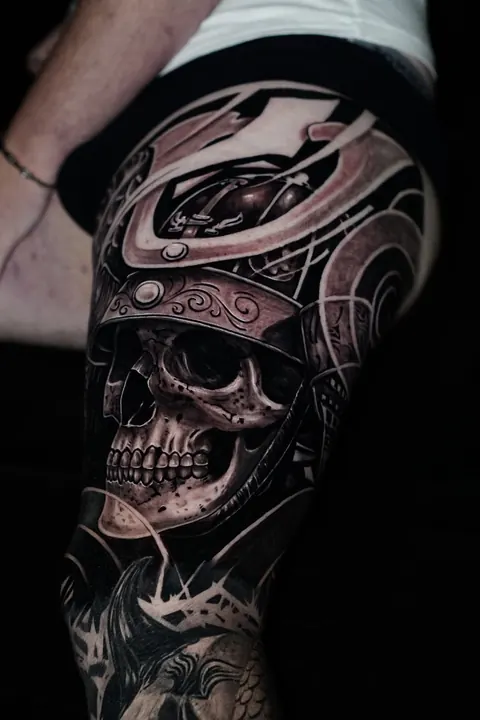 Samurai skull thigh tattoo in black and grey with red detail, tattooed in Seminyak at Mr Ink Bali